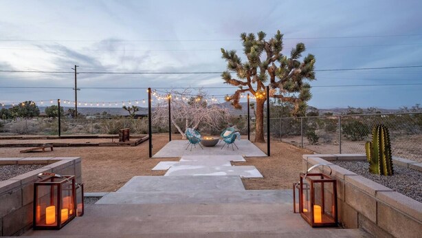 An outdoor patio area with a seating arrangement, a cactus, and string lights. - Soul Shine| Amazing Views | Location | Remodeled, Soul Shine| Amazing Views | Location | Remodeled (Joshua Tree)