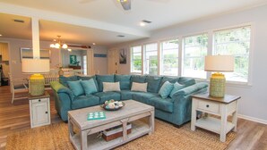 A living room with a sectional sofa, a coffee table, and two nightstands with lamps.