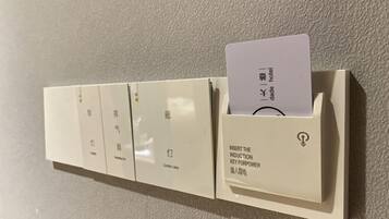 A wall-mounted control panel with multiple buttons and a card slot labeled "INSERT THE INDUCTION KEY FOR POWER."
