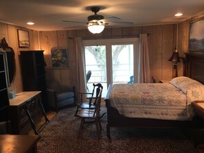 A bedroom with a bed, a desk, a chair, a dresser, and a ceiling fan. - Beautiful , private Bon Secour riverfront home with spacious screened porch (Bon Secour)
