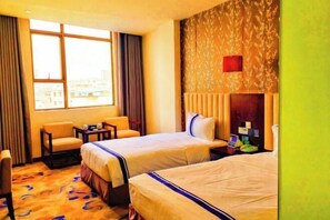 A hotel room with two beds, a small table, a chair, and a window with curtains. - Ganlu Hotel (Yunan) (Yunan)