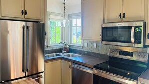 A modern kitchen with stainless steel appliances, a dishwasher, and a double sink. - Fabulous Bungalow, 1 block from 5th Street Market (Eugene)