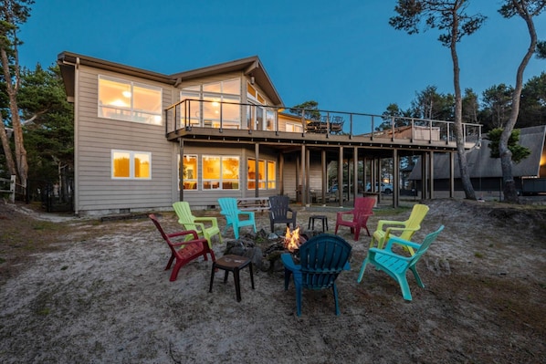 A two-story house with a deck and outdoor seating area.