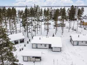 A residential area with multiple houses surrounded by snow-covered ground and trees. - Villa kuortane by Interhome (Kuortane)