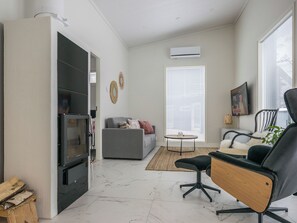 A modern living room with a sofa, armchair, and a coffee table. - Villa kuortane by Interhome (Kuortane)