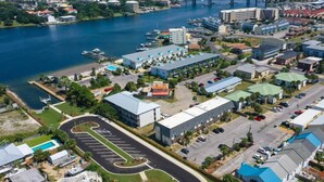 An aerial view of a coastal town with a marina, buildings with flat roofs, and a parking lot. - Next to Kayak Park |1st Floor Condo |Short Walk to Beach |Beach Cart, 2 Chairs & Umbrella |Dogs Ok (Fort Walton Beach)