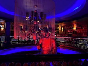 A bar area with a decorative sculpture, hanging lights, and a bar counter. - Egyptian Experience Resort in Nabq, studio with sea views (Sharm El Sheikh)