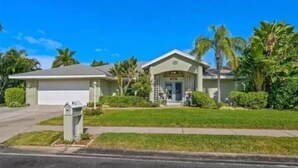 A single-story house with a garage, a front porch, and a well-maintained lawn.