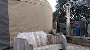 A wooden bench with a label reading "USE PROPER GLOVES WHEN HANDLING." - Bembridge Harbour Yurt - Log Burner - Wifi (Ryde)