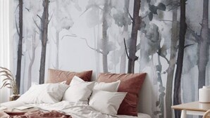 A bedroom with a bed, pillows, and a wall mural of trees. - Charming gite for 10 people with heated pool and mini farm near the ocean (Azur)