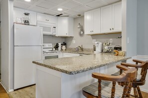 Enjoy cooking in this well-equipped kitchen with oven, microwave, and sink.