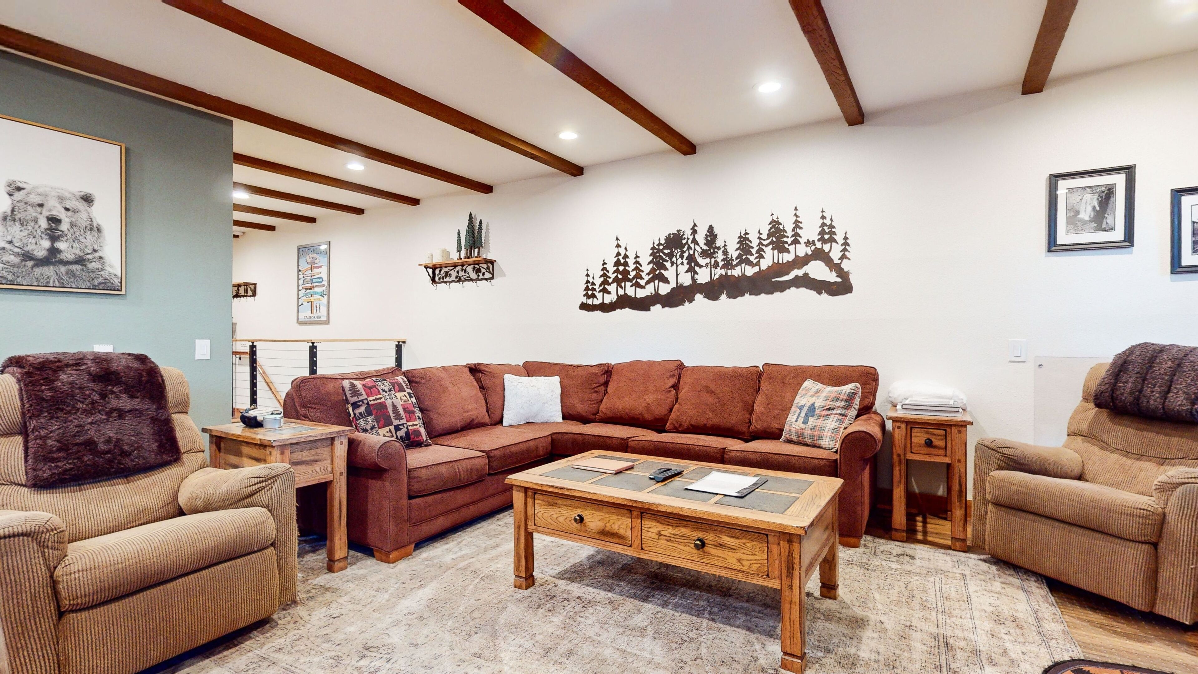 A cozy living room with a sectional sofa, two armchairs, a wooden coffee table, and a rug.