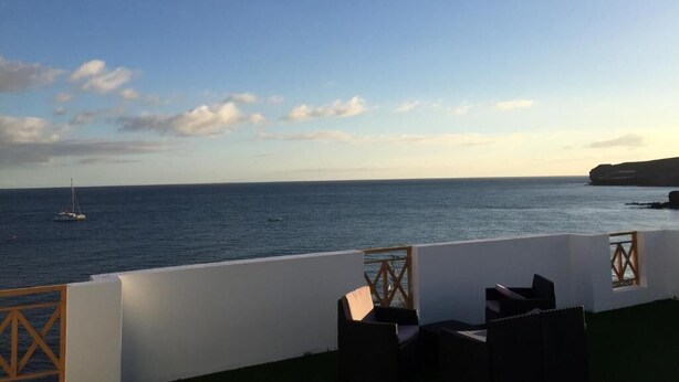 A terrace with a view of the sea and a sailboat in the distance. - LA LAJITA OCEAN VIEW 2 (La Lajita)