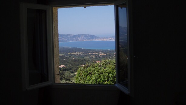 A room with a window overlooking a coastal landscape. - apartment in pretty village (Lumio)