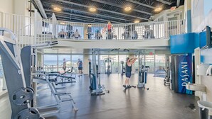 A gym with weightlifting equipment, a mezzanine level, and a view of the ocean. - Luxury and Spacious Condo With Spectacular View (Panama City Beach)