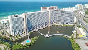 A large hotel with multiple high-rise buildings, a marina, and a body of water. - Luxury and Spacious Condo With Spectacular View (Panama City Beach)