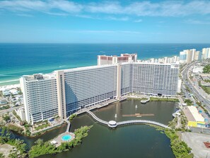 Stunning views of the adjacent water body and a beautifully maintained park with a central fountain.