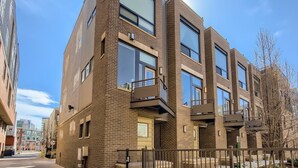 A multi-story building with a brick facade, large windows, and balconies. - Beautiful, Modern Pet-Friendly Downtown Executive Rental (Denver)