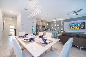 Enjoy meals with family and friends at the dining table for four, surrounded by comfortable chairs.