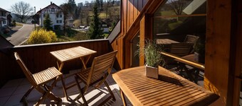 Beautiful penthouse duplex apartment with balcony surrounded by greenery