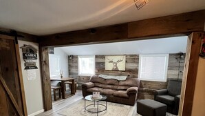 A cozy living room with a brown leather couch, a coffee table, and a fireplace. - Trails Head Cabin (Rock Hill)