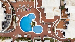 An aerial view of a resort with a central swimming pool, multiple lounge areas, and a parking lot. - Home2Book Sunny Apt Pool & Terrace, Las Américas (Playa de la Américas)