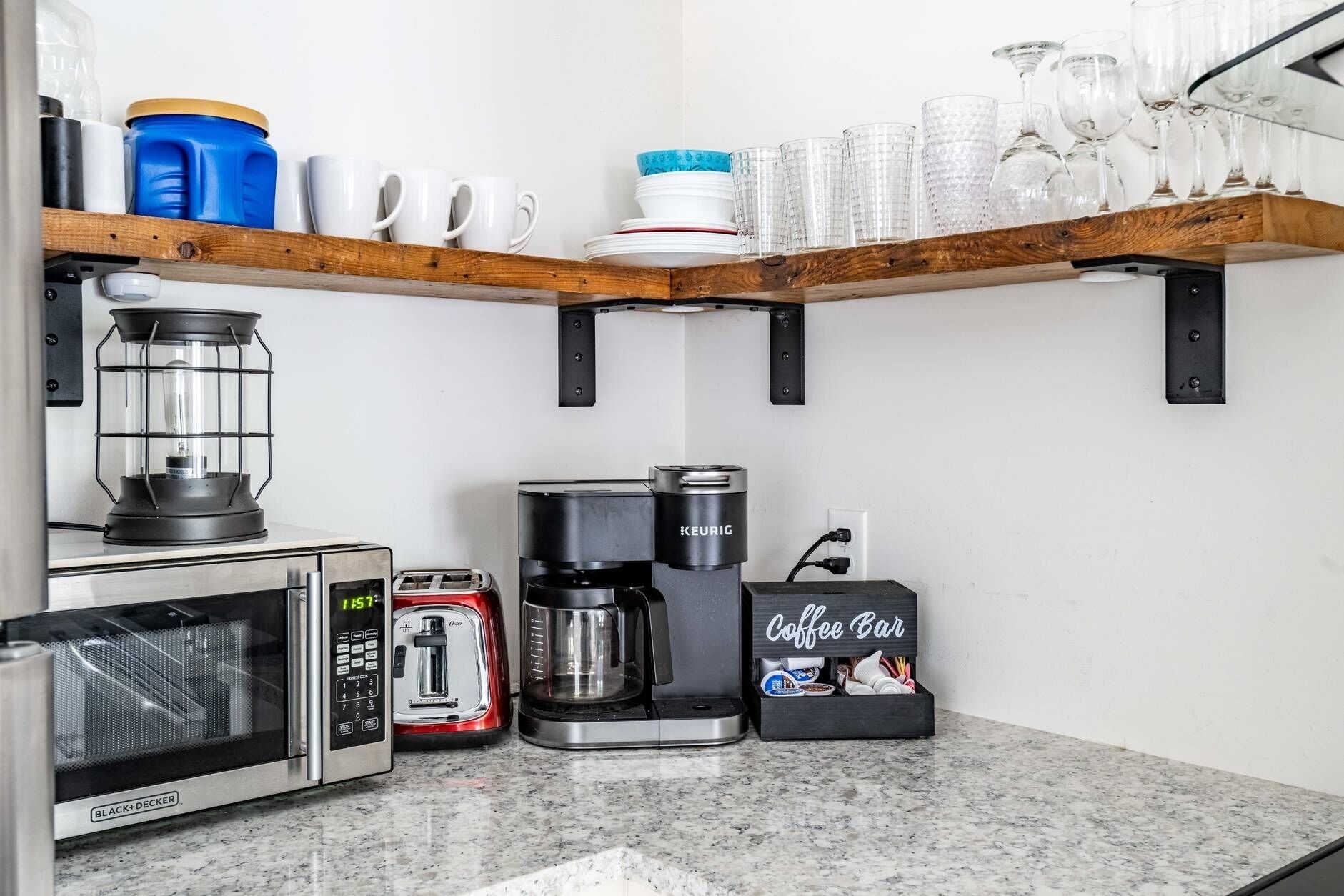 Une cuisine équipée d’une machine à café, d’un grille-pain, d’un mixeur et d’un espace dédié à la préparation du café.