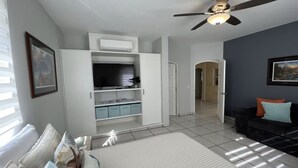 A bedroom with a bed, a ceiling fan, a TV, and a wardrobe. - Beautiful Ocean View Home (Cabo San Lucas)