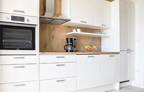 Réfrigérateur, un four, surface de cuisson, lave-vaisselle