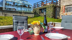 A table set for two with a bottle of Pinot Gris Schram, a vase with flowers, and empty wine glasses. - 2 bedroom awesome home in Burg-Reuland (Burg-Reuland)