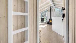 A modern interior with a wooden floor, white walls, and a high ceiling with exposed beams. - 4 bedroom beautiful home in Jerup (Jerup)