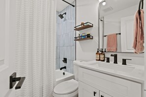 Combined shower/tub, hair dryer, towels, soap