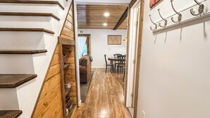 A wooden staircase leading to a loft bedroom with a view of the city. - Croll Cabins-Armstrong Library- #5 at Vallecito Lake, private lawn, great views! (Bayfield)