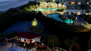 A multi-story hotel with a pool area, beach view, and outdoor seating. - Oceanfront 3 Bedroom/2Bath SeaWatch Resort (Myrtle Beach)