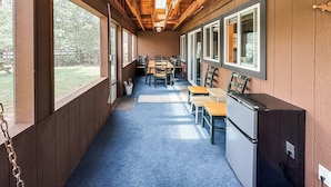 A corridor with wooden walls, large windows, and a blue carpet. - Croll Cabins-Martin Lakeside (#2) at Vallecito Lake (Bayfield)