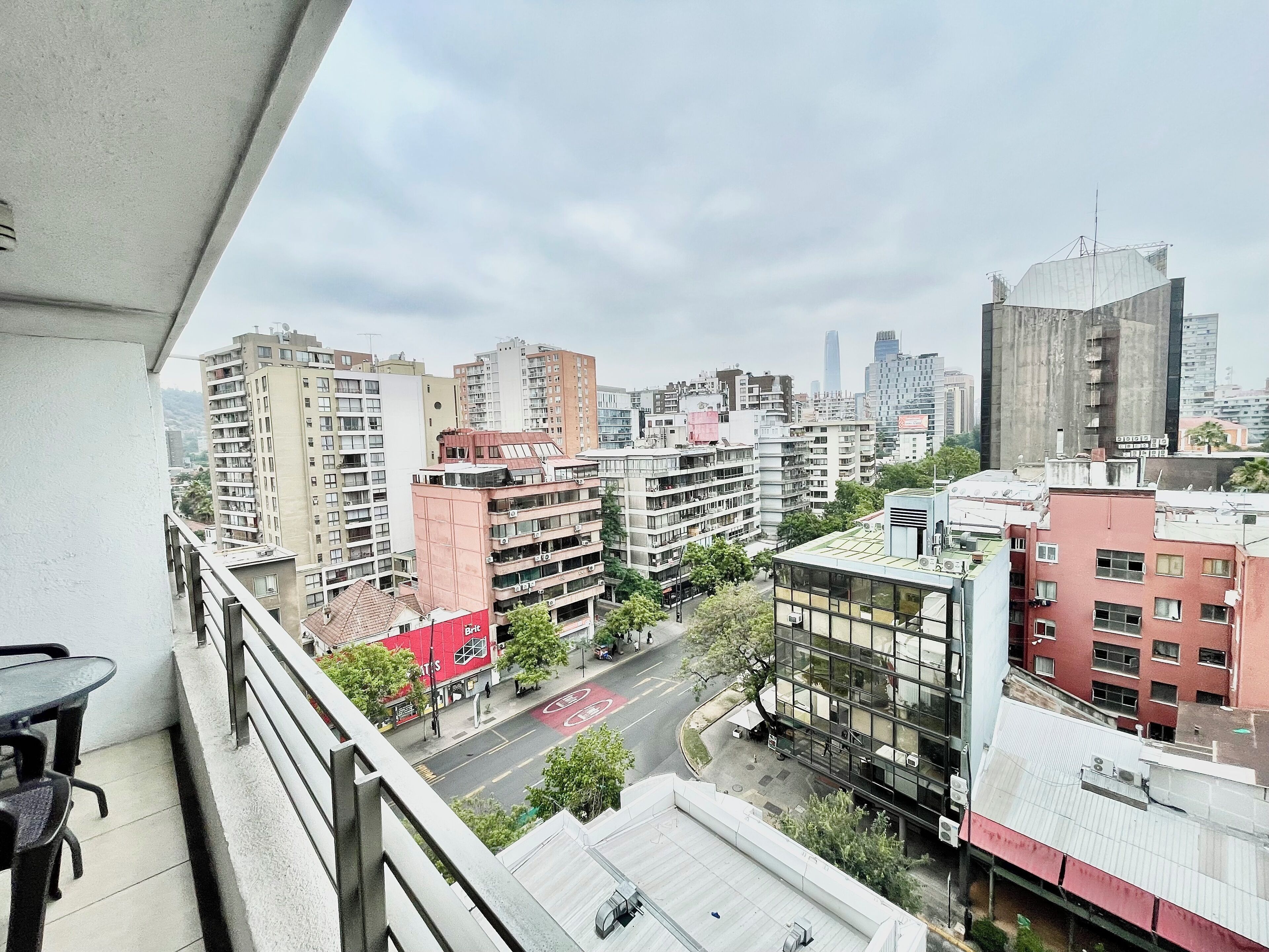 A high-rise building with multiple floors, a mix of residential and commercial buildings, and a clear view of the city skyline.