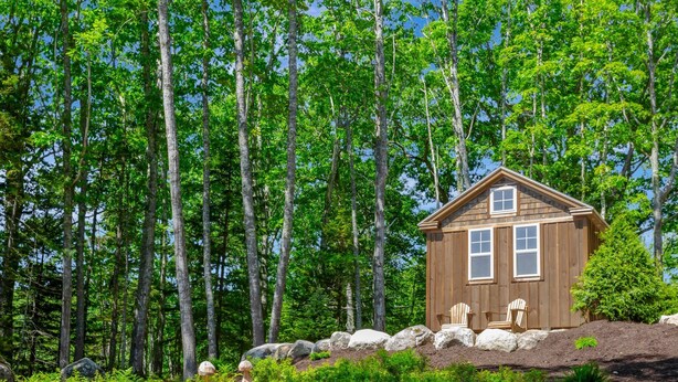 A cabin with two windows, a door, and two chairs outside. - Cabin 1 Near Sandy Point Beach + Wood-Fired Sauna (Stockton Springs)