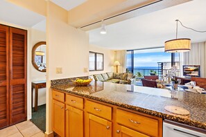 Enjoy ocean views from the balcony and relax in the spacious living area with a sofa.
