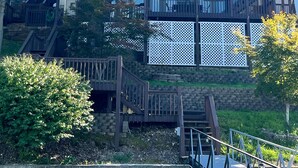 A multi-story building with a balcony on the upper floor, surrounded by trees. - Lake front with orovate dock located in same cove as Coconuts!!! (Gravois Mills)