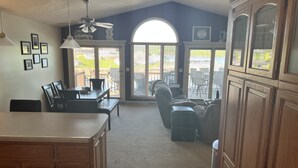 A spacious kitchen with a dining area, a large window, and a ceiling fan. - Lake front with orovate dock located in same cove as Coconuts!!! (Gravois Mills)