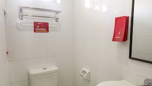 A small, clean bathroom with a toilet, sink, and a window above the toilet. - Vaccinated Staff - OYO 850 Clr Mn Inn (Quezon City)