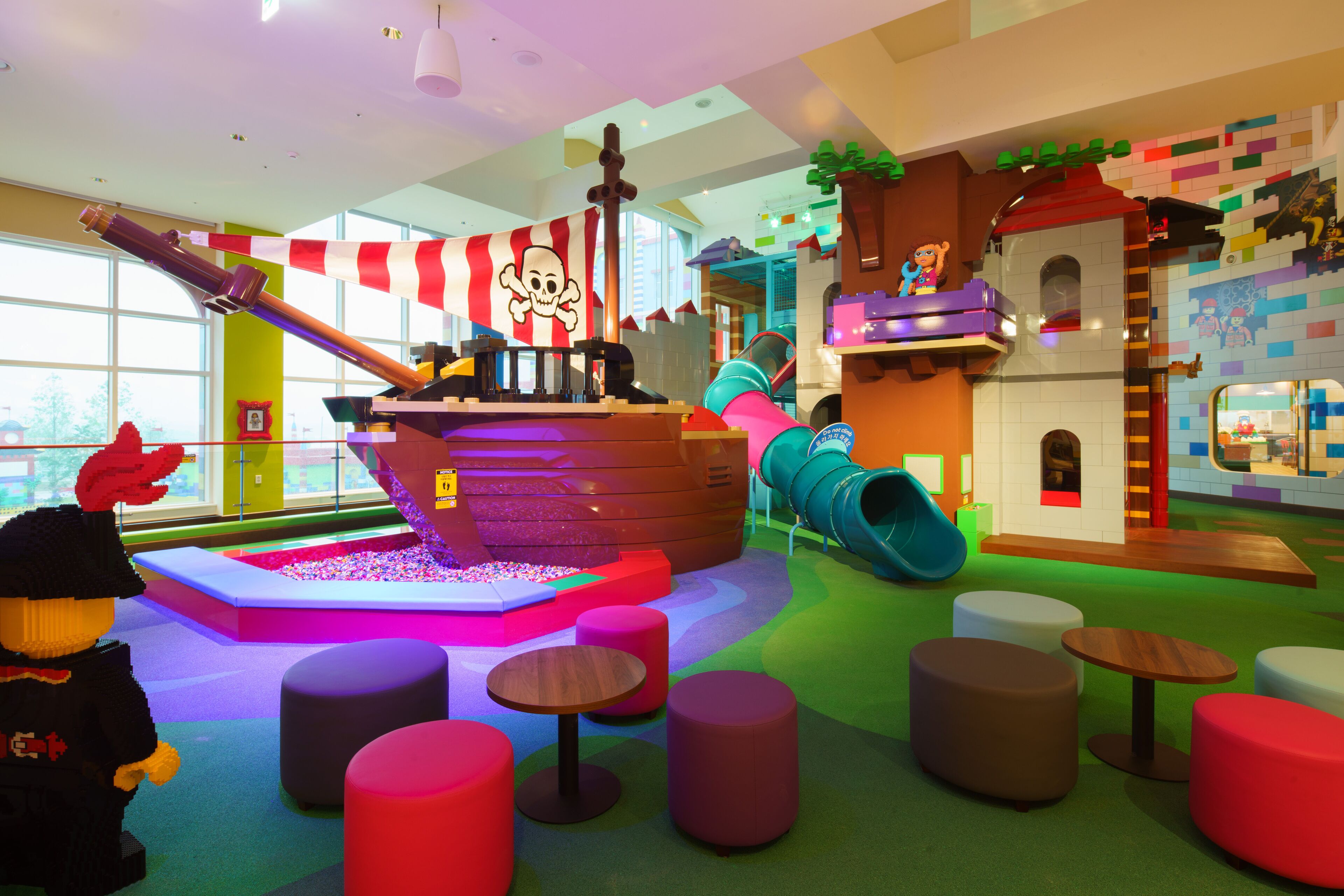 A children's play area with a pirate ship, slides, and colorful play structures.