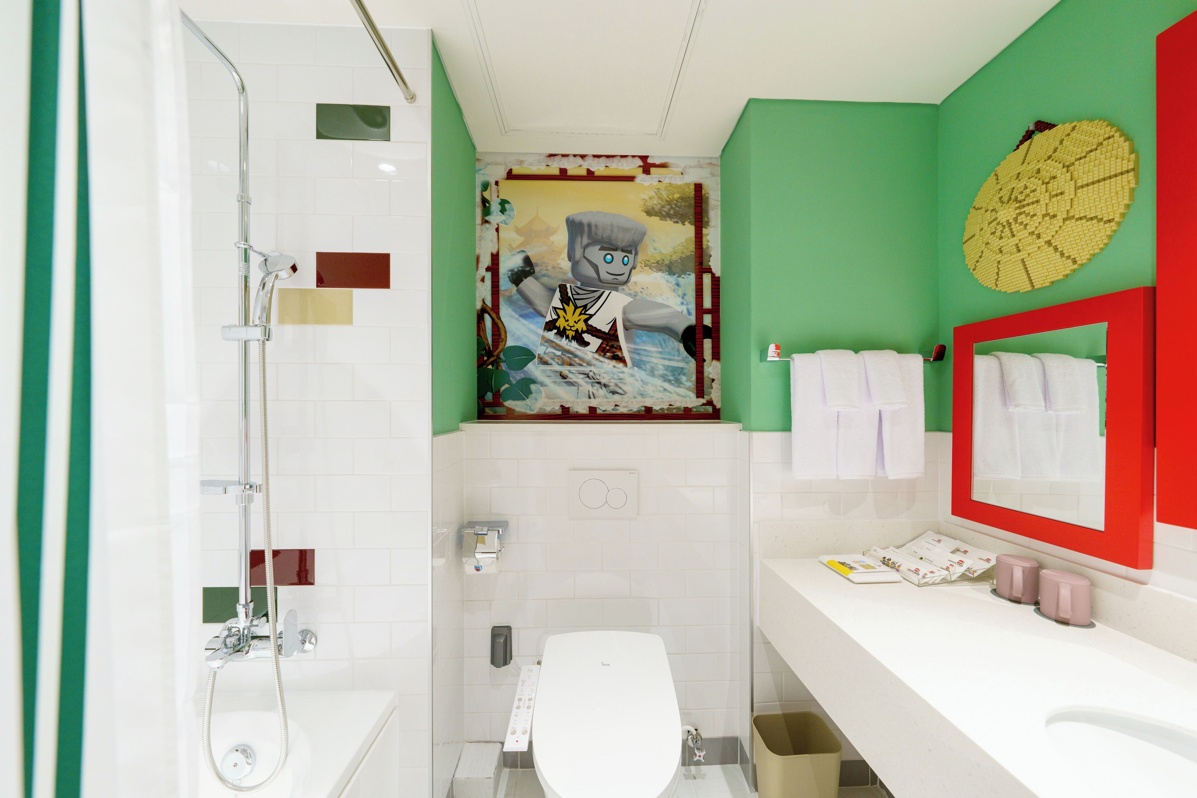 A bathroom with a shower, toilet, and sink.