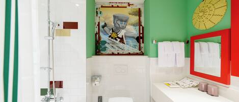 A bathroom with a shower, toilet, and sink.