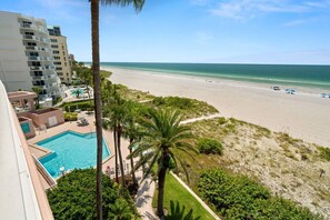 A beachfront hotel with a pool, palm trees, and a view of the ocean. - Beachfront! Gorgeous Views! Pool, Hot Tub, Tennis Courts, Fitness Room ~ 5F Crescent Beach Club (Clearwater)