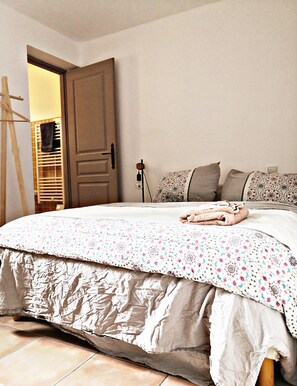 A bedroom with a bed, a wooden wardrobe, a hanging towel rack, and a bedside lamp. - Rustic B&B w/Private Bathroom, Free Parking (Gémenos)