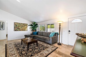 Relax in this inviting living space with a comfortable sectional sofa, coffee table, and cozy rug.