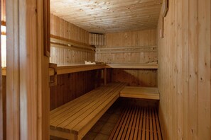 Eine Sauna mit Holzbänken und Lamellenböden.