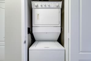 A stacked washer and dryer unit in a laundry room. - Stylish White Plains 2 Bed, By Metro-North Transit (White Plains)