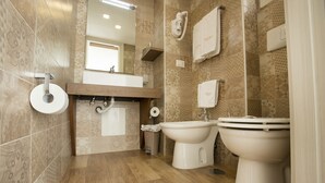 A modern bathroom with two sinks, a toilet, and a shower. - Palazzo Depretis Naples (Naples)